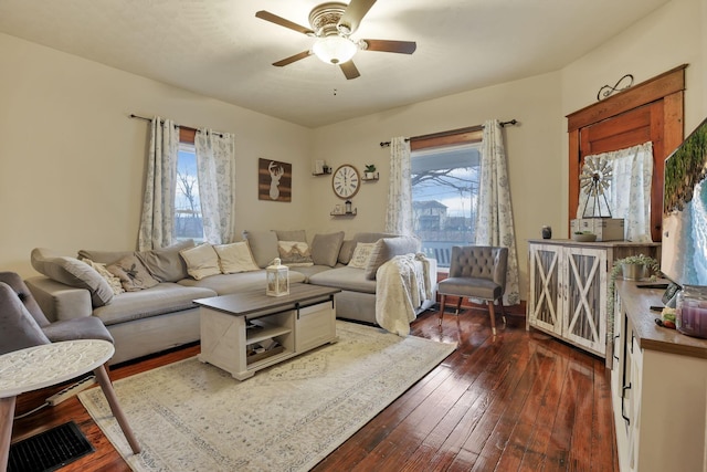 living room featuring dark hardwood / wood-style floors and ceiling fan