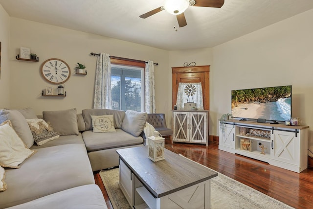 living room featuring ceiling fan and dark hardwood / wood-style floors