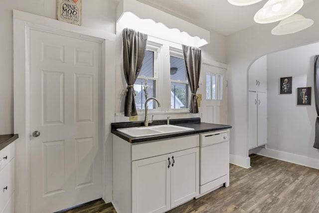 kitchen featuring white dishwasher, dark hardwood / wood-style floors, white cabinets, and sink