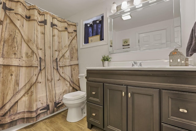 bathroom featuring a shower with curtain, vanity, toilet, and wood-type flooring