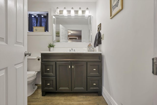 bathroom featuring hardwood / wood-style floors, vanity, and toilet