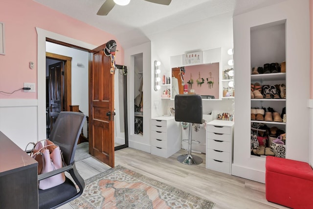 home office featuring ceiling fan, a textured ceiling, and light wood-type flooring