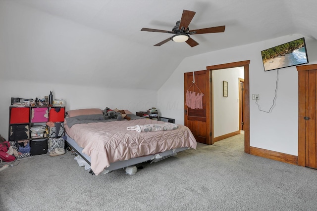 bedroom featuring ceiling fan, light carpet, and vaulted ceiling