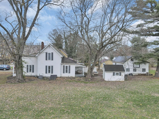 exterior space featuring a yard and central AC