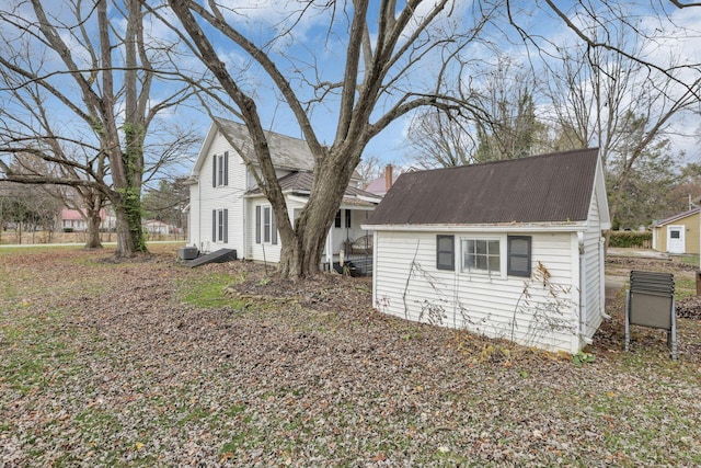 view of side of home with central AC