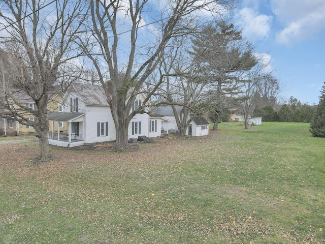 view of yard with covered porch and a storage shed