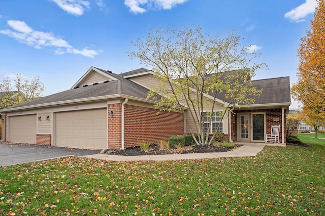 view of front of house with a garage and a front lawn