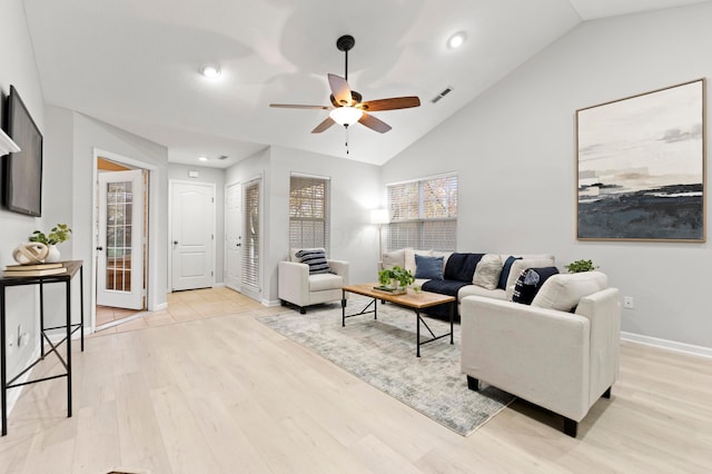 living room with light hardwood / wood-style flooring, ceiling fan, and lofted ceiling