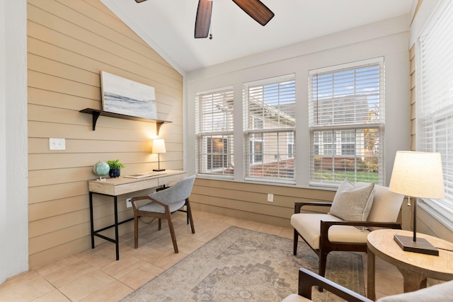 tiled home office featuring wood walls, plenty of natural light, and vaulted ceiling