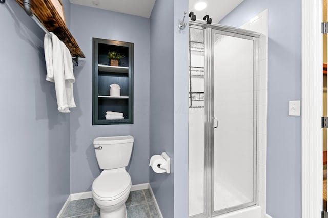 bathroom featuring tile patterned floors, an enclosed shower, and toilet