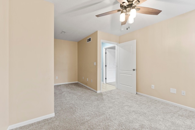 unfurnished room with ceiling fan and light carpet