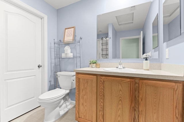 bathroom with tile patterned flooring, vanity, and toilet