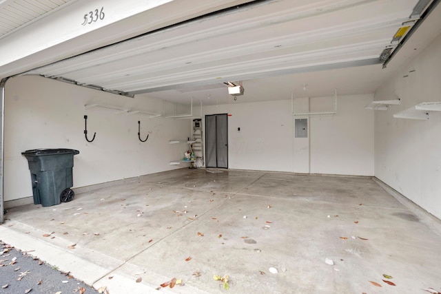 garage with electric panel and a garage door opener