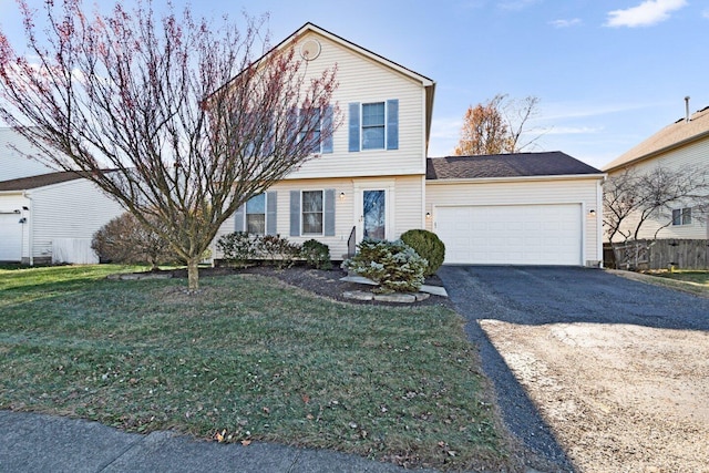 view of front of house featuring a front lawn and a garage