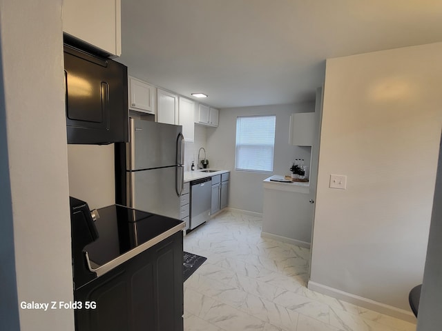 kitchen featuring white cabinets, stainless steel appliances, and sink