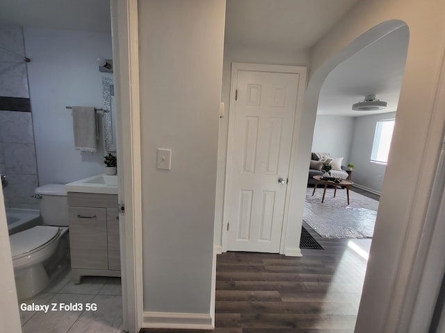 bathroom featuring vanity, hardwood / wood-style flooring, and toilet