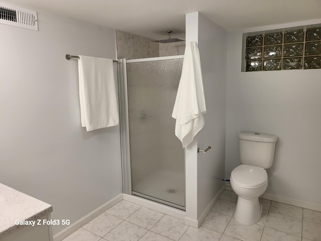 bathroom with vanity, a shower with shower door, and toilet