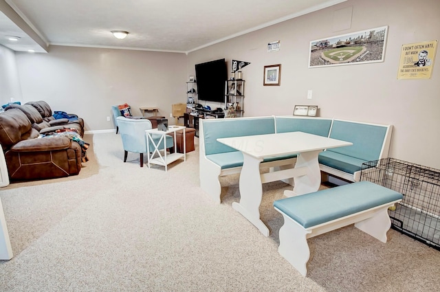 carpeted dining space featuring ornamental molding