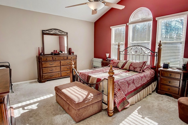 bedroom featuring vaulted ceiling, light carpet, and ceiling fan