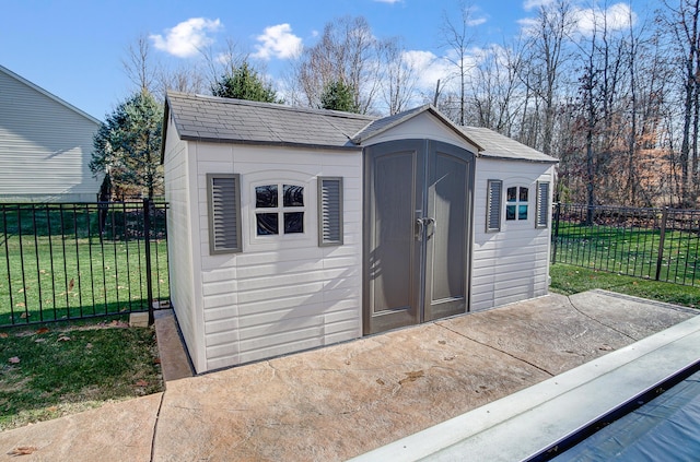 view of outbuilding featuring a yard