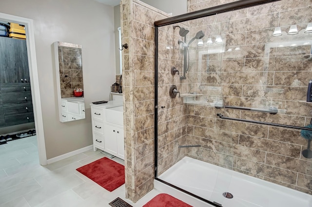 bathroom with vanity, a shower with shower door, and tile patterned flooring