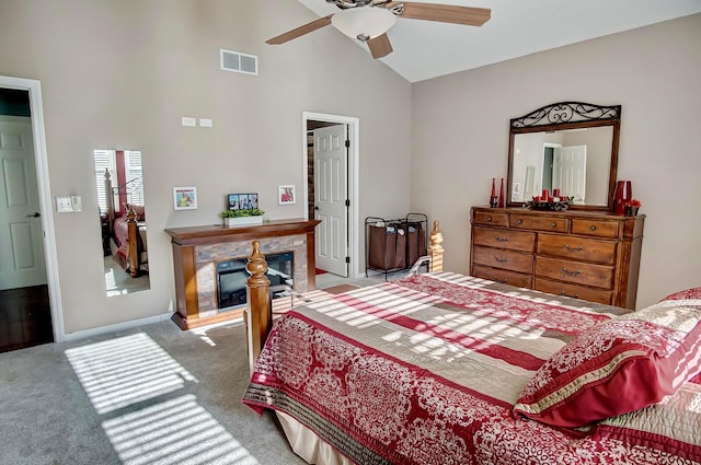 carpeted bedroom with high vaulted ceiling and ceiling fan