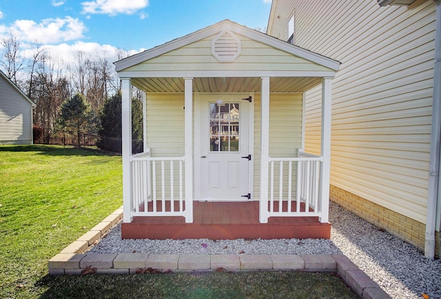 view of exterior entry with a lawn