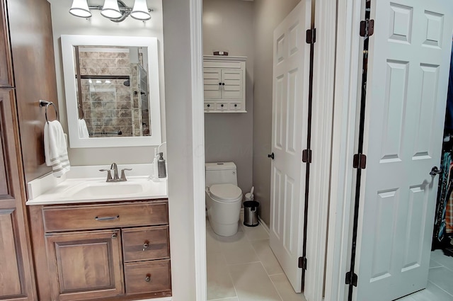 bathroom featuring tile patterned floors, toilet, vanity, and a shower