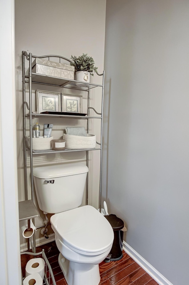 bathroom with hardwood / wood-style flooring and toilet