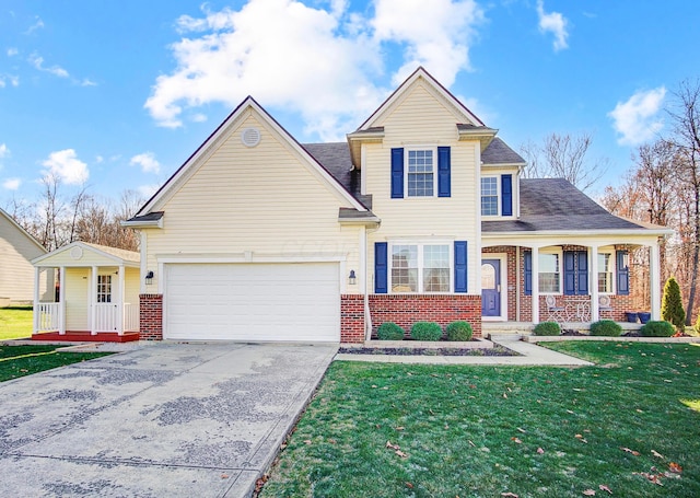 view of front of house featuring a garage, covered porch, and a front lawn