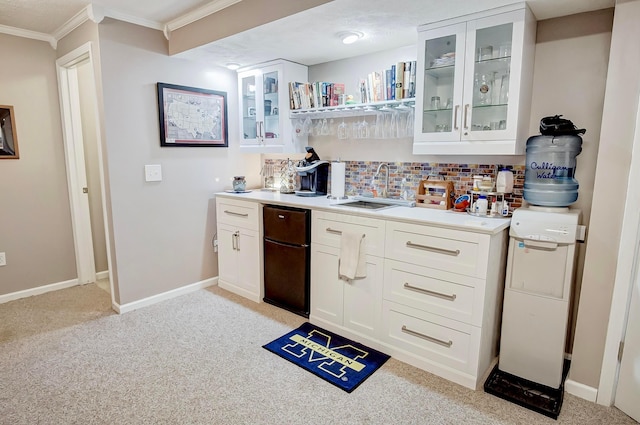 bar with light carpet, sink, backsplash, and white cabinets