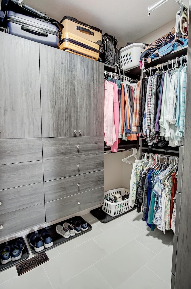 spacious closet featuring tile patterned flooring