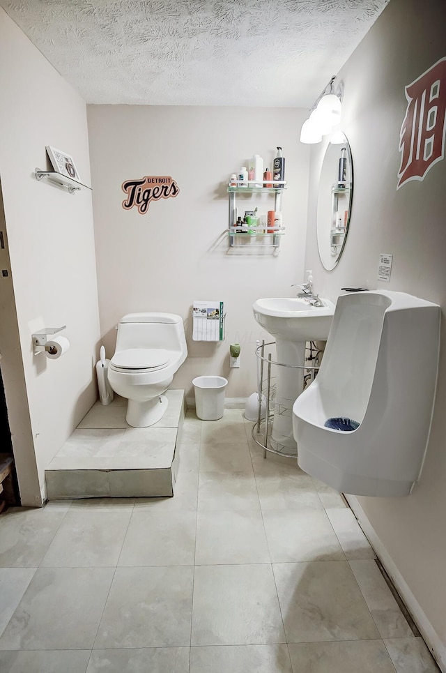 bathroom with sink, a textured ceiling, and toilet