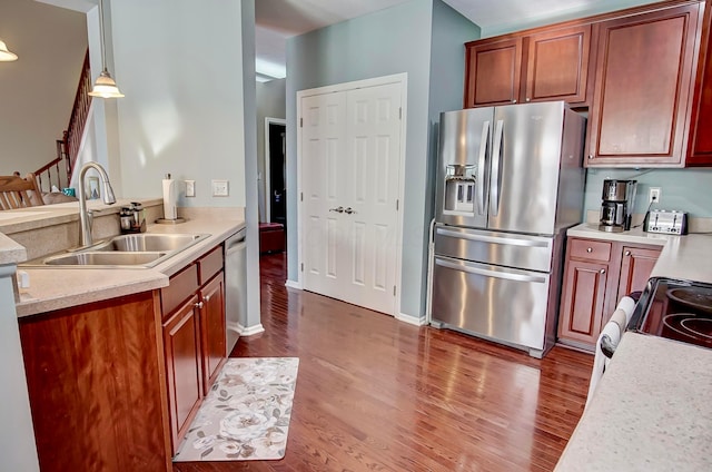 kitchen featuring sink, decorative light fixtures, dark hardwood / wood-style floors, and appliances with stainless steel finishes