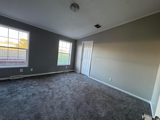 unfurnished room featuring dark colored carpet and vaulted ceiling