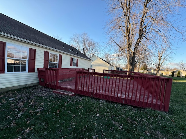 wooden deck featuring a yard