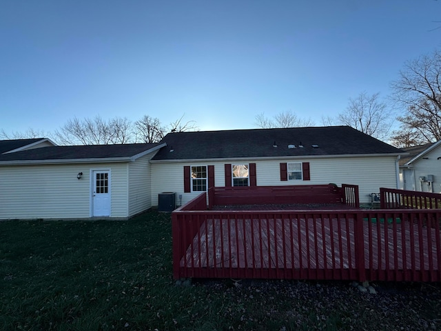 rear view of property featuring a deck and central AC unit