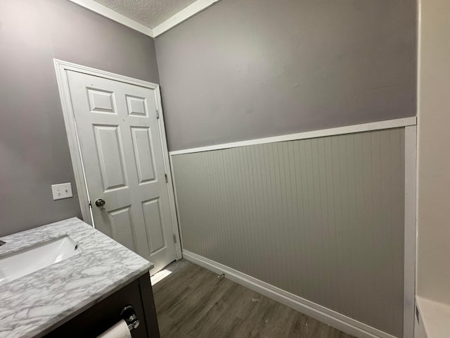 clothes washing area featuring sink, dark hardwood / wood-style flooring, and a textured ceiling