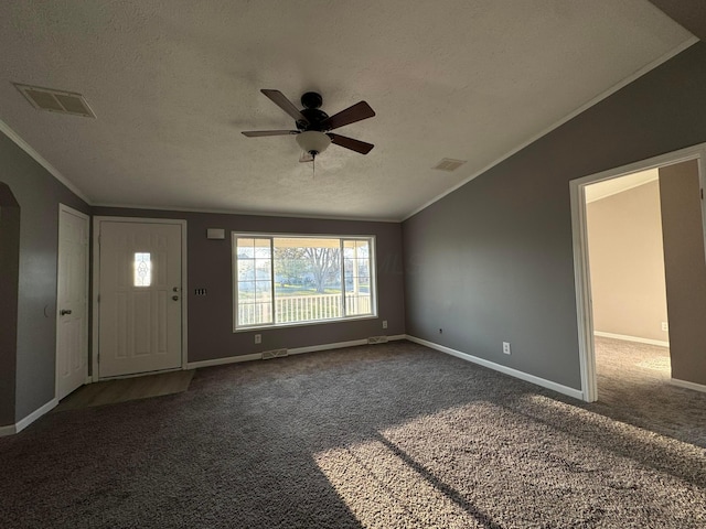 foyer entrance with dark colored carpet, a textured ceiling, ceiling fan, and lofted ceiling