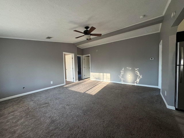 carpeted spare room with a textured ceiling, ceiling fan, and vaulted ceiling