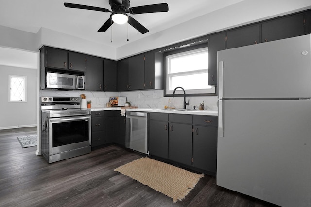 kitchen with ceiling fan, sink, tasteful backsplash, dark hardwood / wood-style floors, and appliances with stainless steel finishes