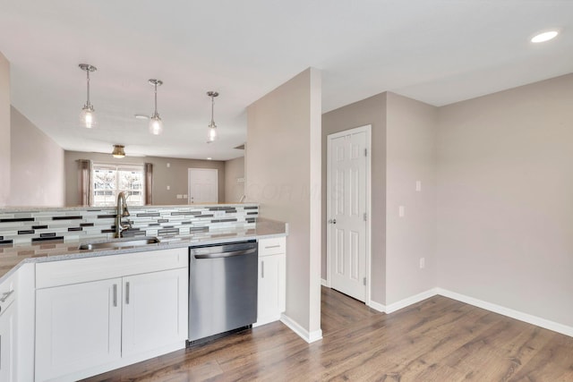 kitchen with sink, white cabinets, decorative light fixtures, stainless steel dishwasher, and light stone counters