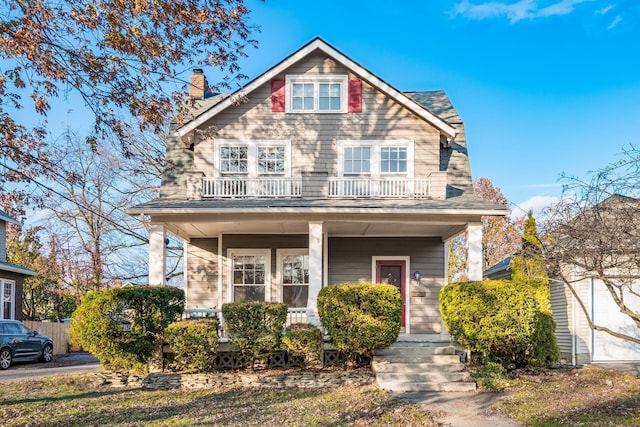 view of front of home with covered porch and a balcony