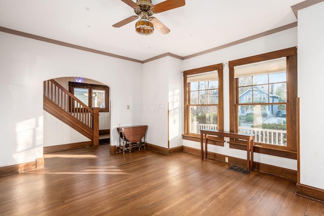 interior space featuring hardwood / wood-style flooring, ceiling fan, and crown molding