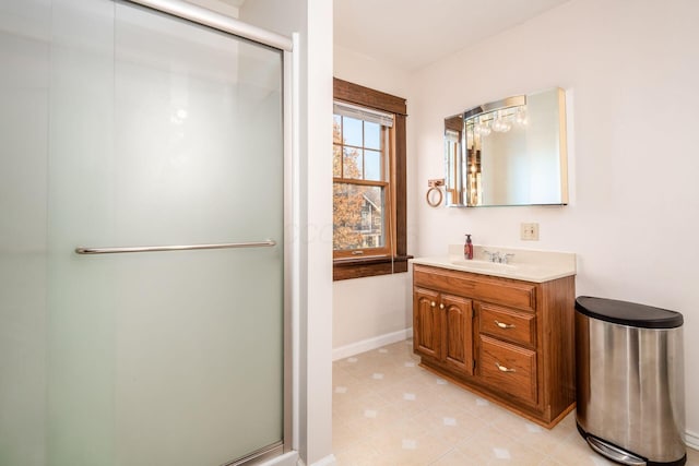 bathroom with vanity and a shower with door