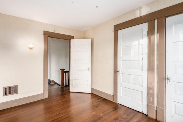 unfurnished room featuring dark hardwood / wood-style flooring