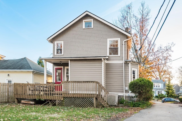 back of house with a deck