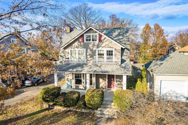 view of front of house featuring covered porch, a balcony, and a garage