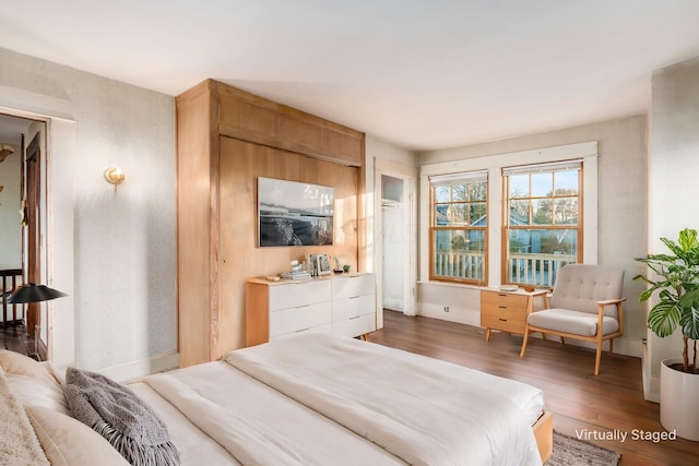 bedroom with dark hardwood / wood-style floors