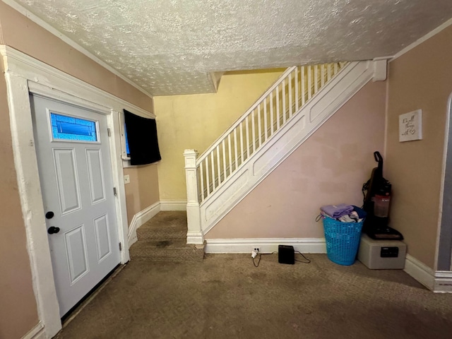 foyer with carpet floors and a textured ceiling